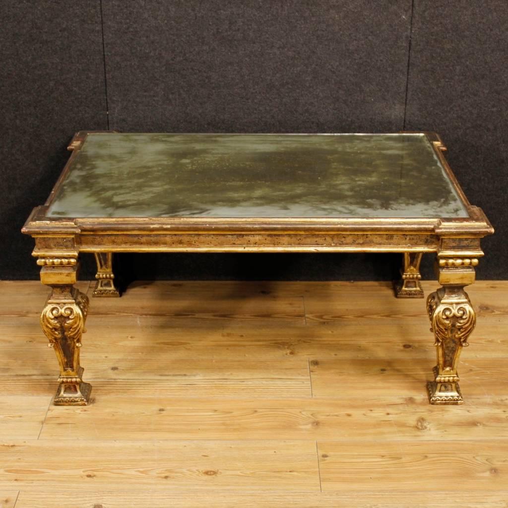 Italian coffee table of the 20th century. Furniture in Louis XVI style in richly lacquered and gilded wood and plaster. Coffee table for living room complete with top with recessed mirror of great size and service. Furniture of fabulous decoration