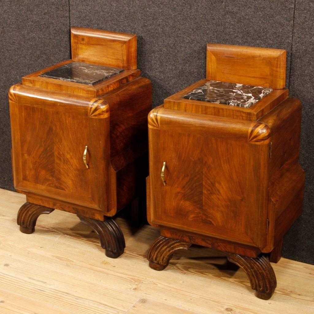 Pair of Italian bedside tables from the mid-20th century. Art Deco style furniture carved in walnut wood with inlay on the doors, of beautiful line and pleasant furnishings. Night stands with a door of good capacity and service. Top with recessed