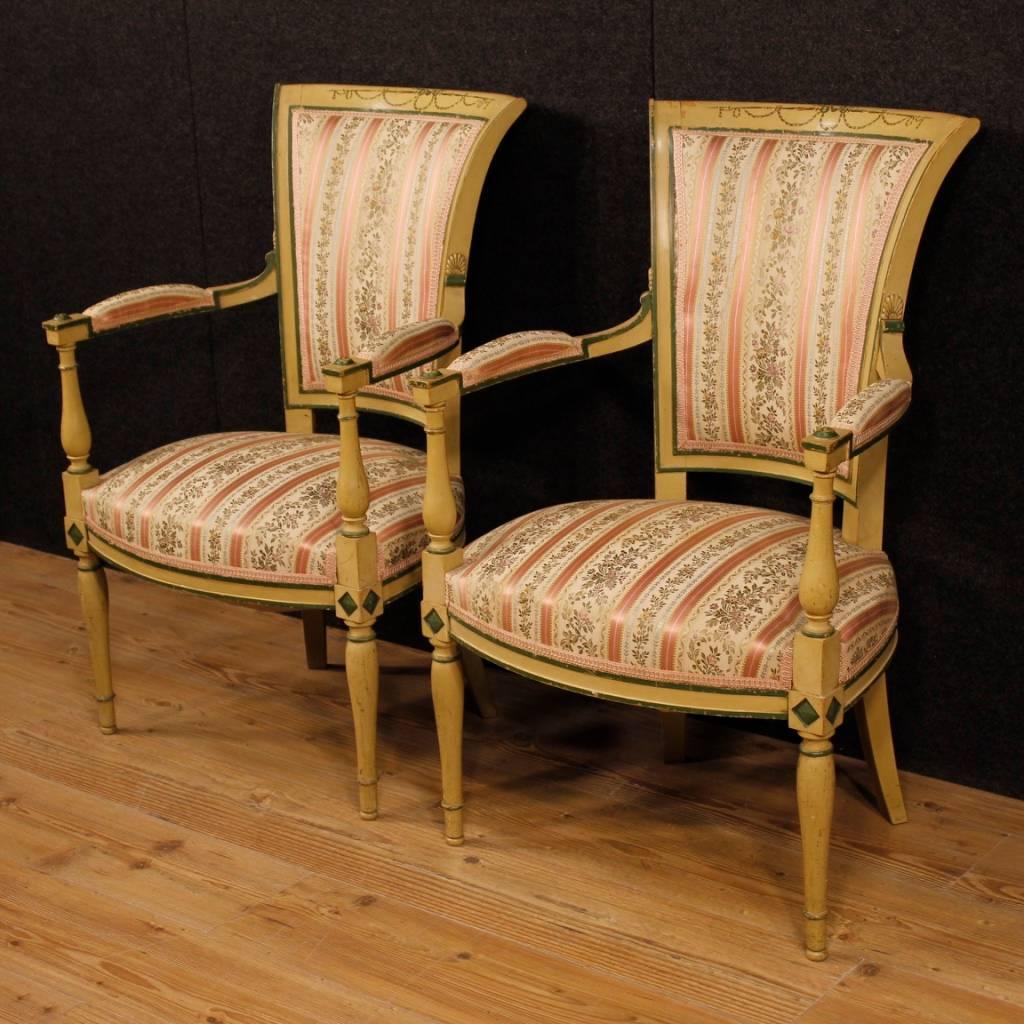 Pair of French armchairs from the mid-20th century. Furniture in carved, lacquered and hand-painted wood with floral decorations of great pleasure. Armchairs for living room covered in floral fabric in good condition, with some small signs of wear.