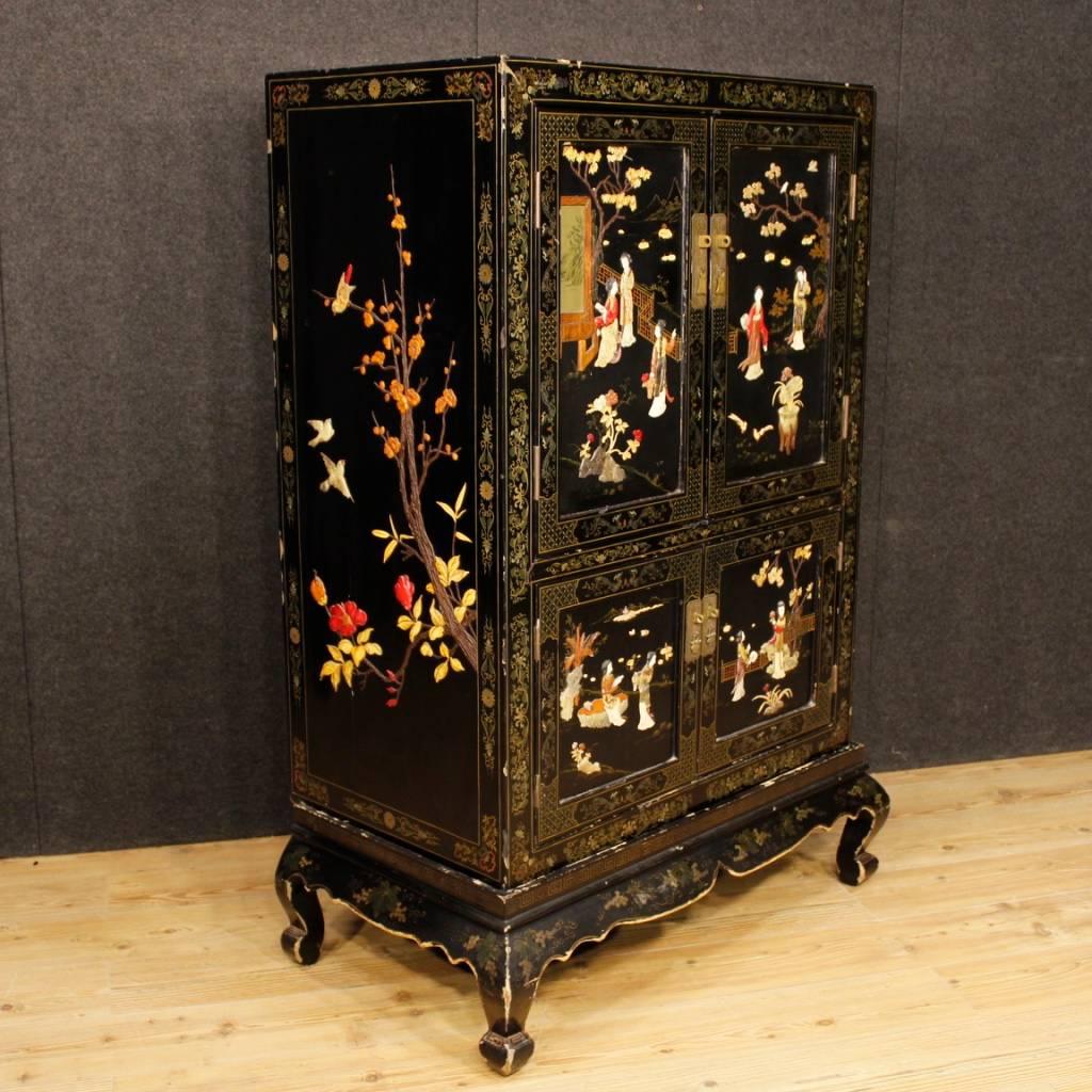 French sideboard of the 20th century. Furniture composed of two elements (basement and sideboard) richly lacquered, painted and decorated with soapstone chinoiserie decorations. Four-doors sideboard of excellent capacity and service missing internal