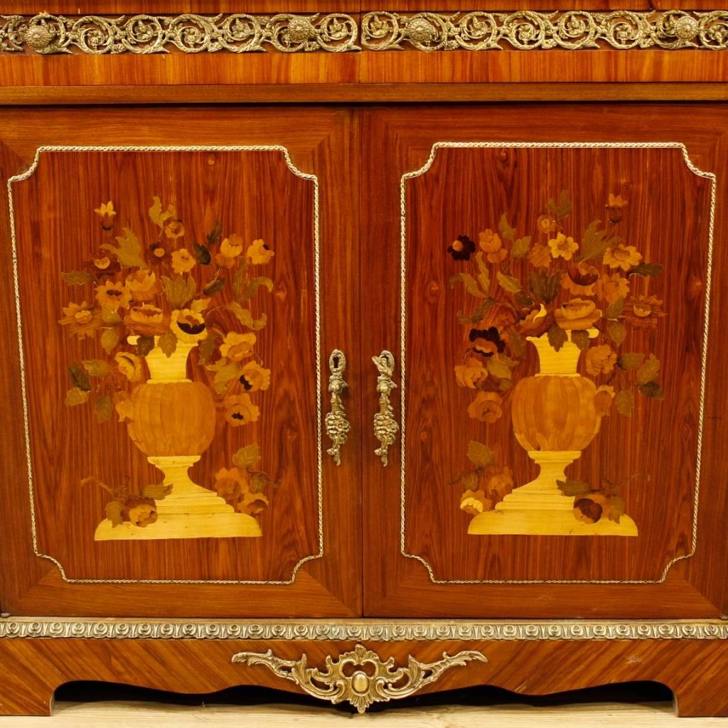 French sideboard of the 20th century. Furniture in various precious woods adorned with floral inlay and richly decorated with gilded and chiselled brass and bronzes. Sideboard with two doors and two drawers of good capacity and service. Furniture