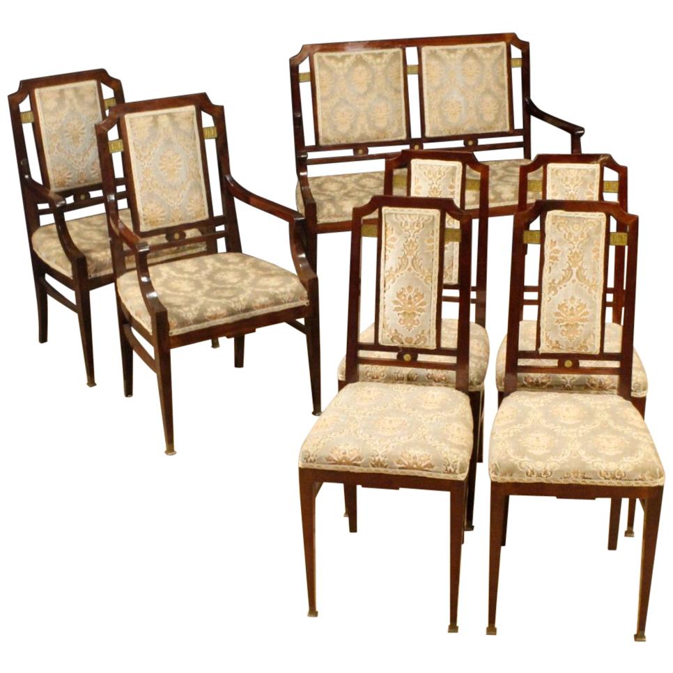 Pair of Art Deco French armchairs from the first half of the 20th century. Furniture carved in mahogany wood with golden wood decorations on the back, brass feet and small bronze decoration. Pleasant upholstered armchairs in velvet of beautiful