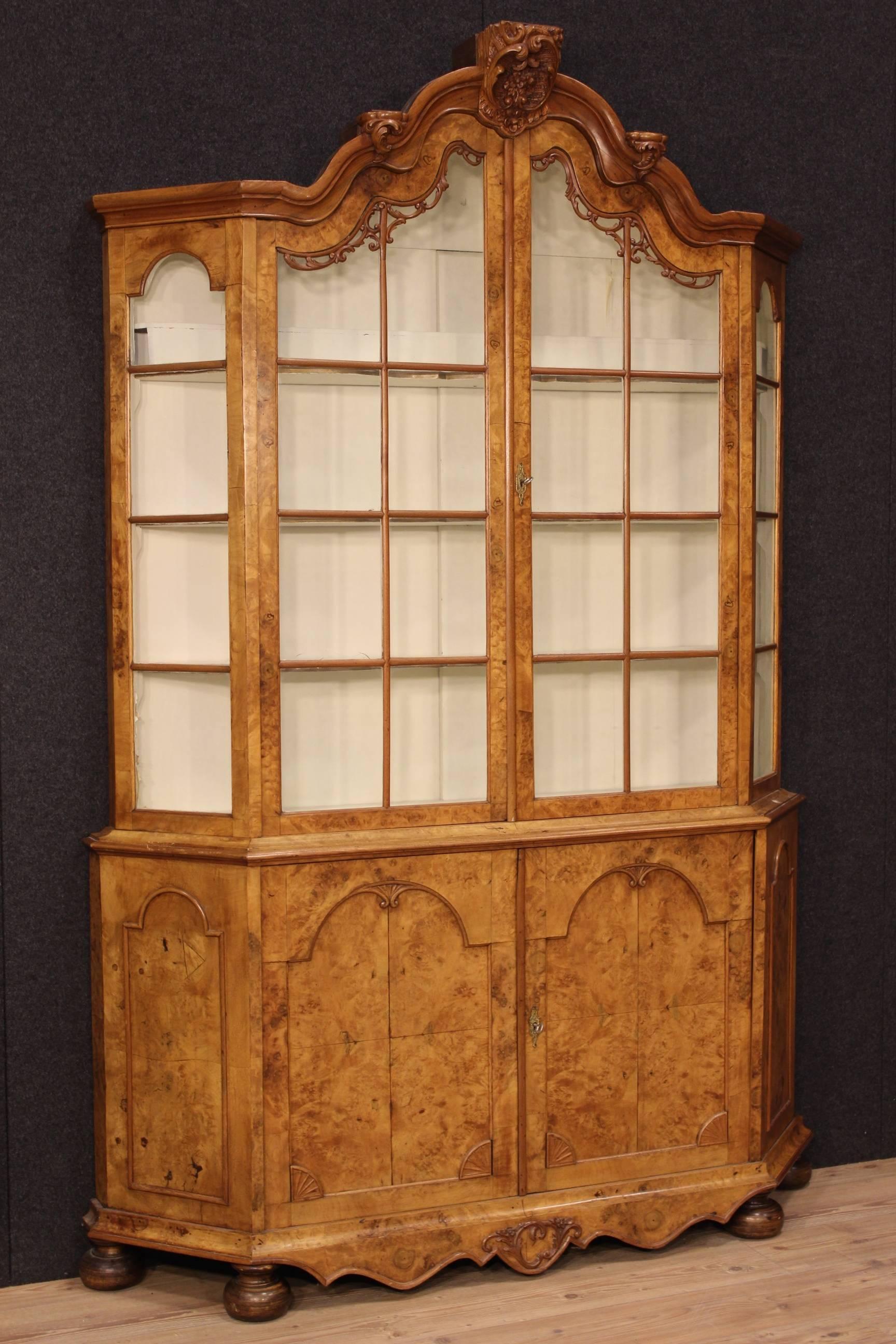 Dutch bookcase of the late 19th century. Furniture carved in walnut and burl elm. Vitrine built as a sideboard in the lower part and as a showcase with two doors in the upper part. Furniture complete with two functioning keys. Painted inside of the