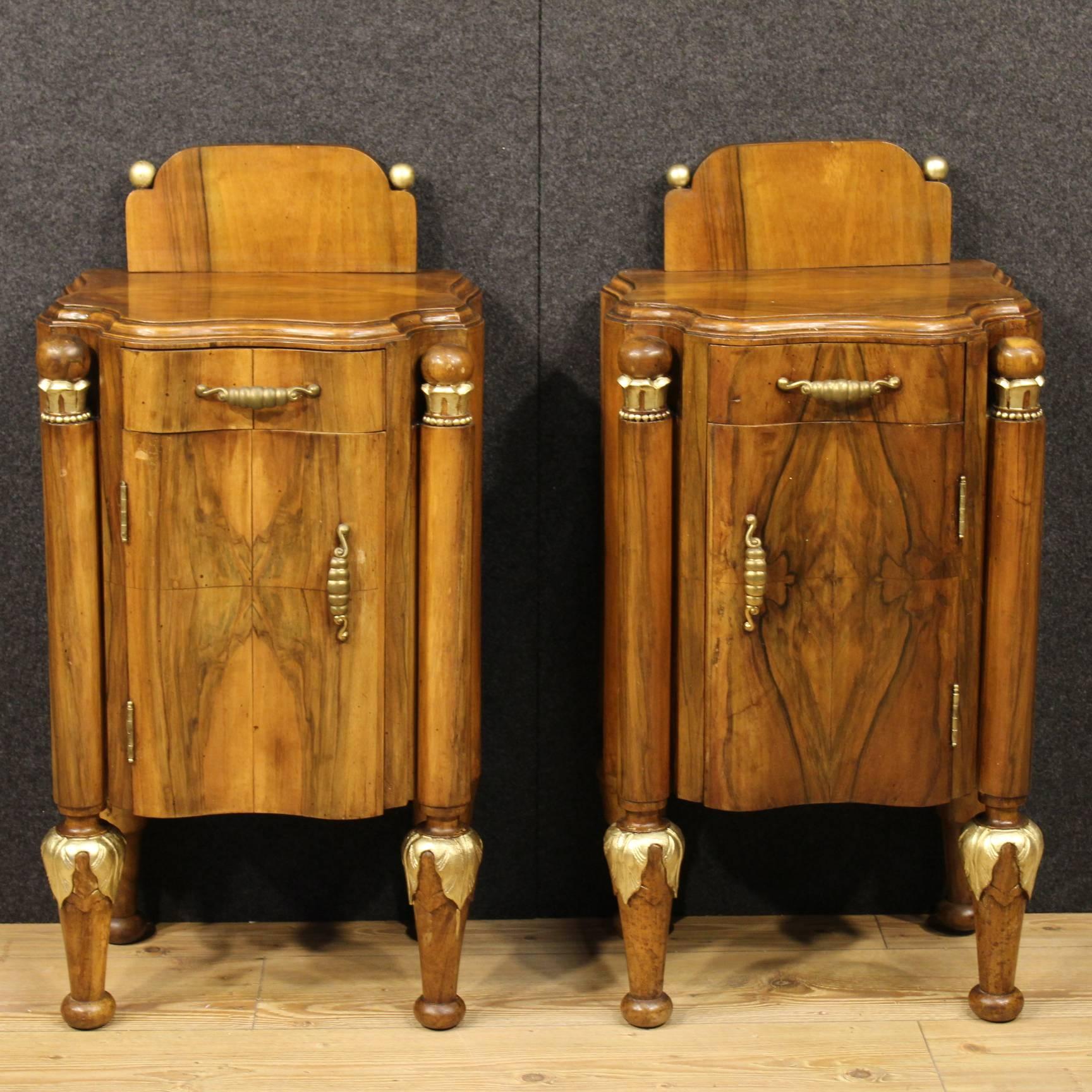 Interesting pair of Italian bedside tables of the 20th century. Furniture made by carved walnut and decorations of gilding. Bedside tables with one door and one-drawer of good ability and service. Furniture of high proportion ideal to be placed in a