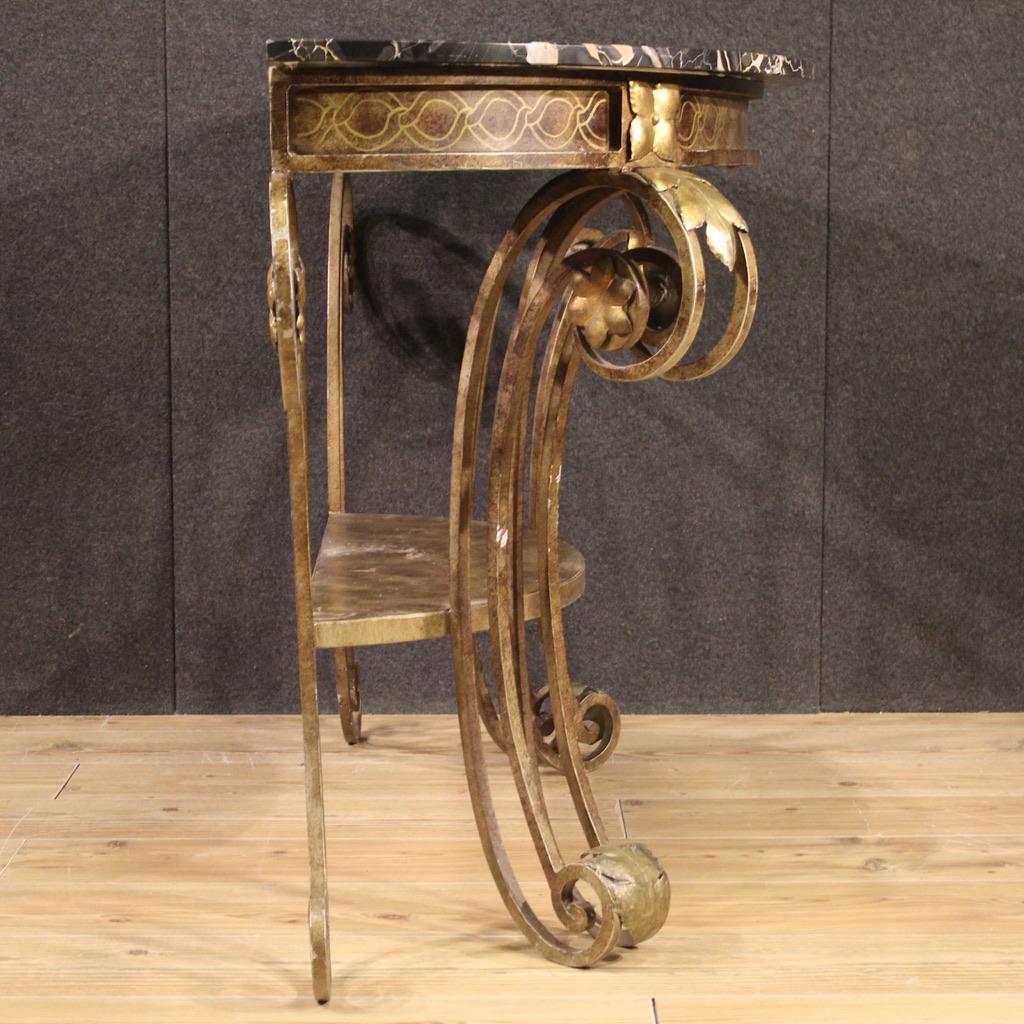 Elegant Italian console in wrought and gilded iron from the 70s. Spectacular top in Portoro marble from Portovenere, with some signs of aging (see photo). Spectacular piece of furniture in an eclectic Art Deco style, ideal for a reception room or