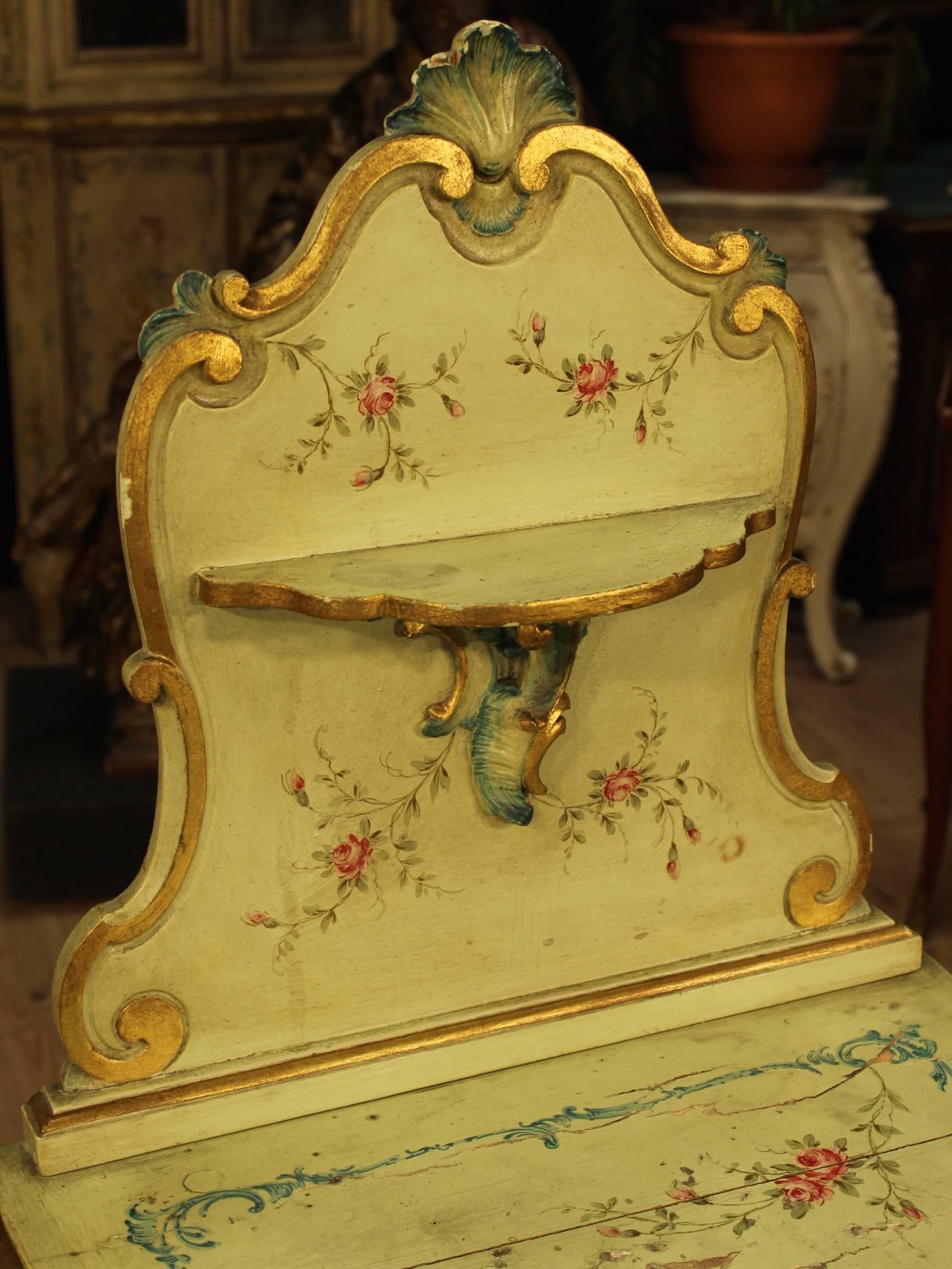 Pretty Venetian bedside table. Furniture made by nicely carved, gilded, lacquered and hand-painted with floral motifs wood. Nightstand with a drawer and a door of good ability and service. Furniture provided with a shelf section also lacquered. 20th