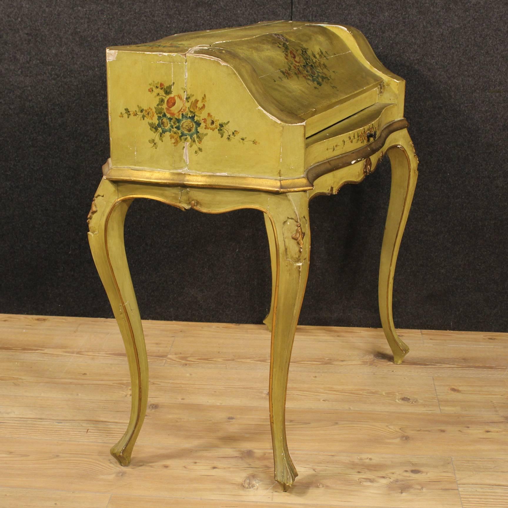Pretty Venetian bureau of the 20th century. Furniture made by ornately carved, lacquered, gilded and painted with floral decorations wood of great taste and nice decoration. Bureau with high leg finished from center equipped with an external drawer