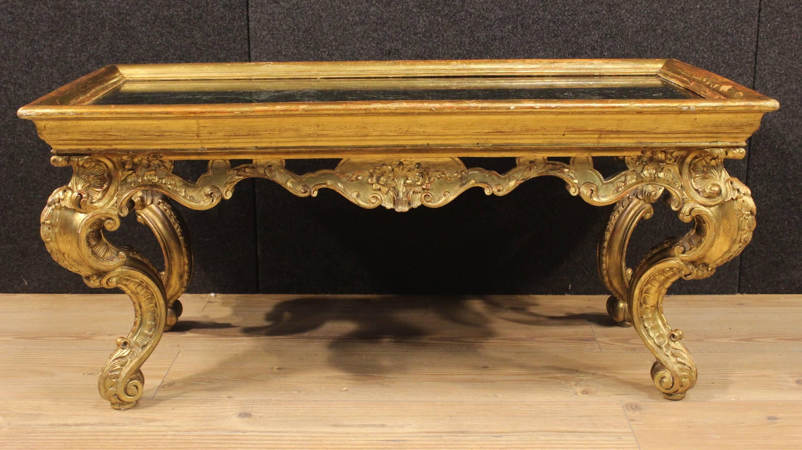 Stylish French table of the 20th century. Furniture made by ornately carved and gilded wood of fabulous line and pleasant decor. Low table of high quality supported by four moved legs of good solidity. Top in original recessed marble of beautiful