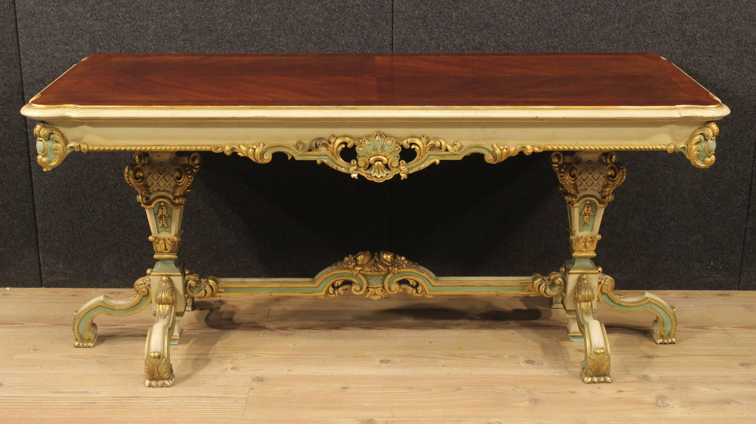 Ornately carved, lacquered and gilded wooden table. French coffee table of high quality with mahogany upper floor. Furniture supported by a richly carved wooden structure of great decoration and good taste. 20th-century table, of excellent