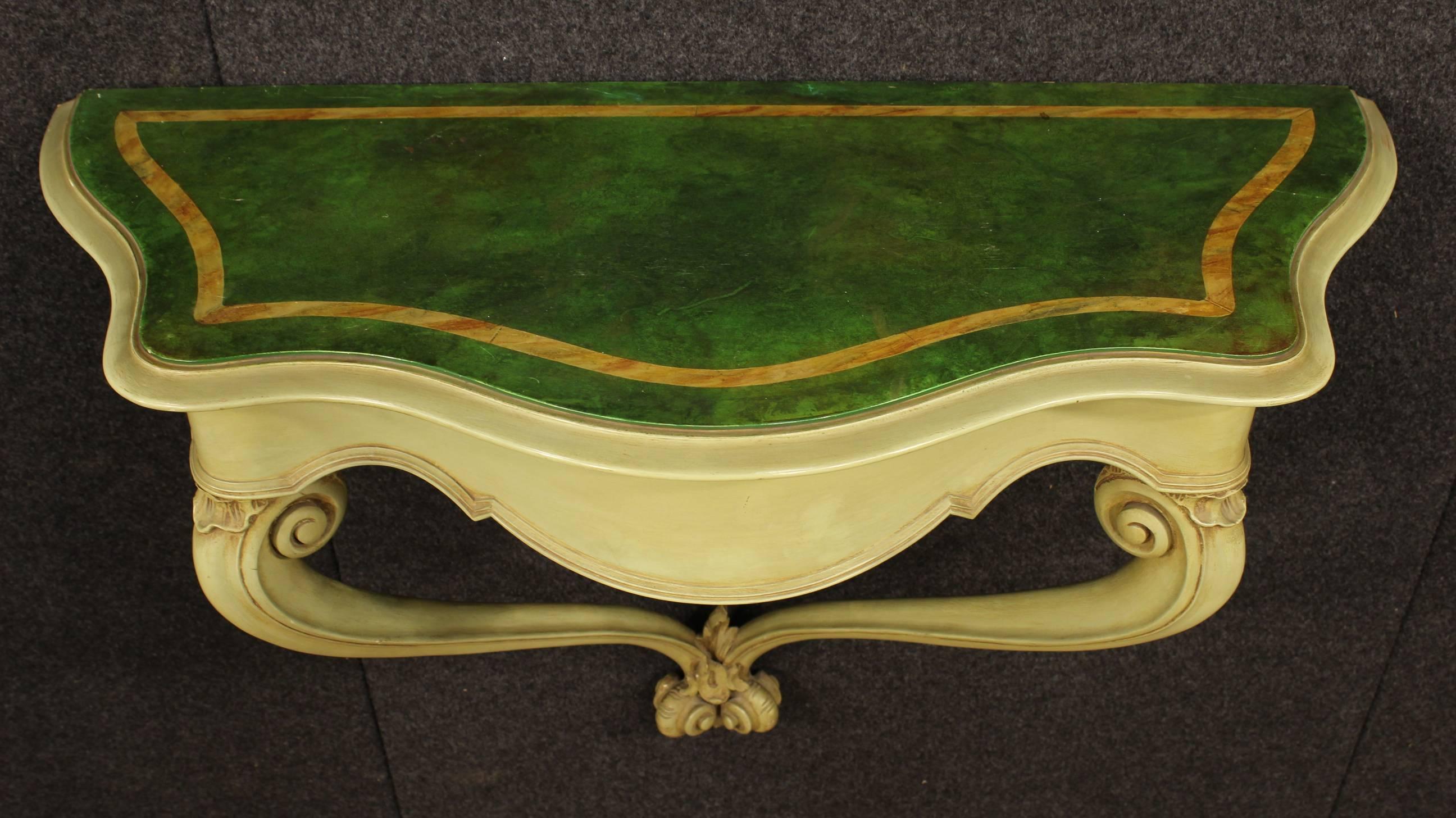 Pretty Venetian console table of the 20th century. Furniture made by carved and painted wood with lacquered faux marble top. Console table fixed to the wall for a perfect stability. Top of discrete measurement and service. Furniture of high