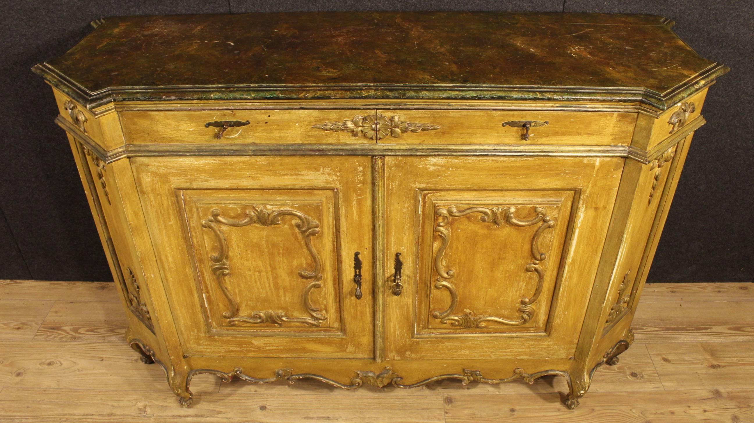Scenic Venetian sideboard of the 20th century. High-impact furniture of beautiful decoration made by ornately carved, painted and gilded wood. Sideboard with two doors and two drawers, of large capacity and service provided with large top made by