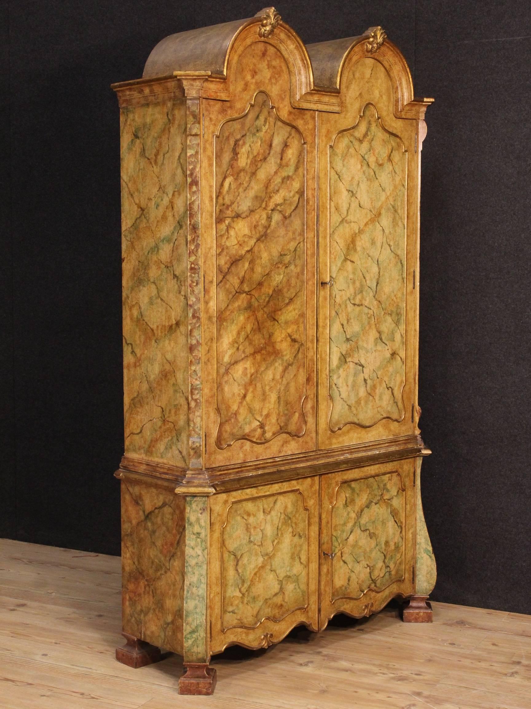 French wardrobe of the second half of the 20th century. Furniture in carved, gilded and lacquered faux marble wood of great taste and spectacular decor. Sideboard with four high capacity and service doors, complete with two working keys. Furniture