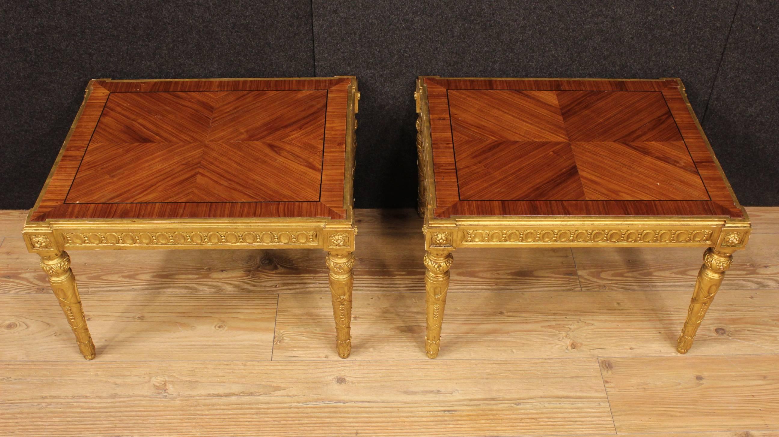 Beautiful pair of Italian coffee tables of the 20th century. Furniture in ornately carved and gilded wood in Louis XVI style with top in rosewood. Living room coffee tables of good taste and decoration of nice size and discreet service. High