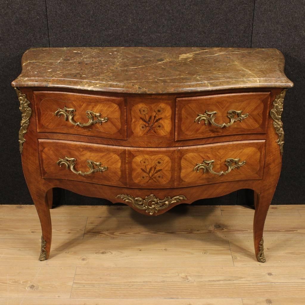 French dresser of the mid-20th century. Moved and curved furniture in rosewood, mahogany, maple and palissander, richly decorated with gilded and chiseled bronze. Chest of drawers with three drawers, of large capacity with top in original marble of