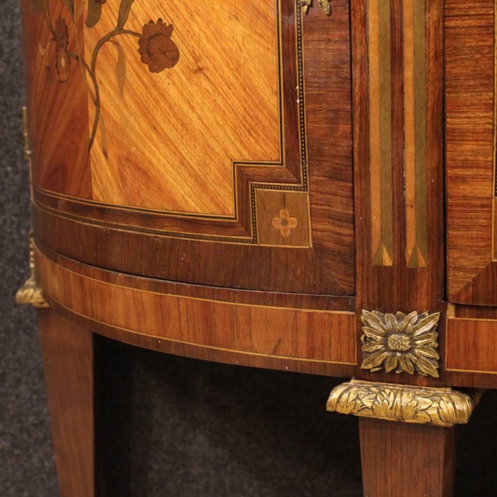 Elegant French demi lune dresser from the early 20th century. Furniture in nicely inlaid rosewood, palisander, maple, boxwood and fruitwood, of beautiful line and good taste. Dresser with three frontal drawers, two side pull-out drawers and two side