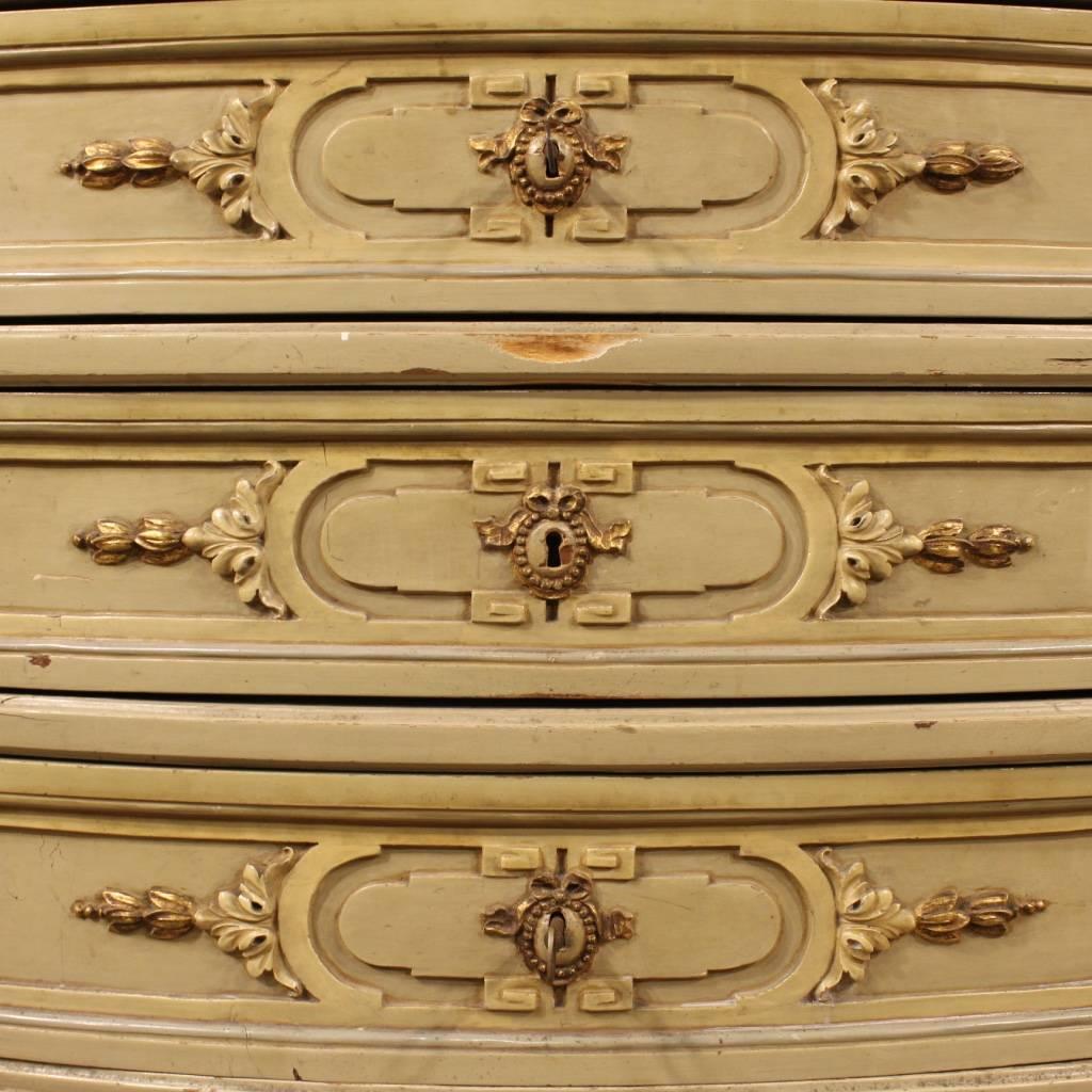 Italian demilune dresser from the half of the 20th century. Furniture in ornately carved, painted and gilded wood with gilded and chiseled bronze handles, of great taste. Dresser of great size and impact with original marble top floor in perfect