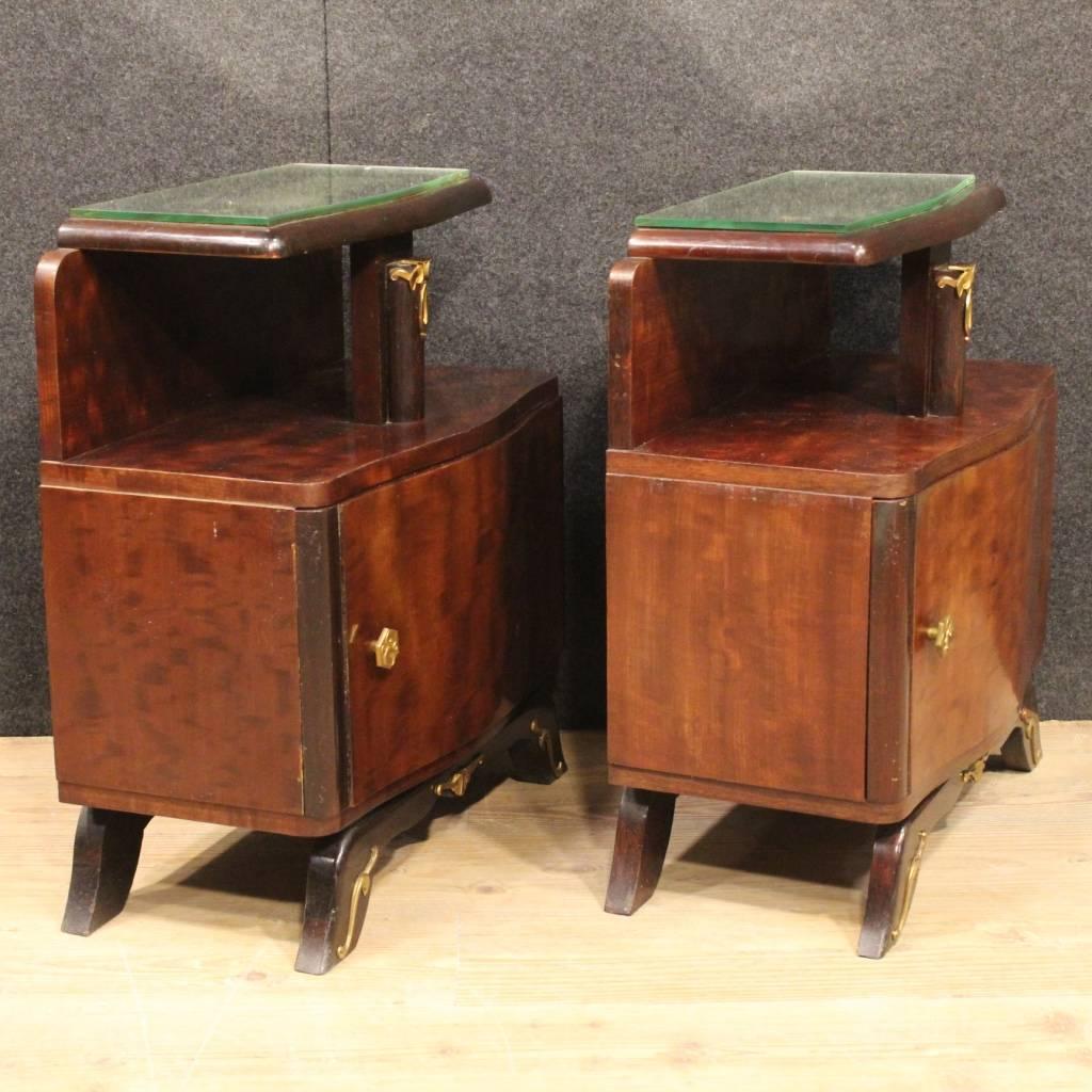 Beautiful pair of French bedside tables of the mid-20th century. Furniture of beautiful line and good taste in Art Deco style pleasantly decorated with gilt and chiseled brass applications. Bedside tables equipped with a frontal door and mirror top,