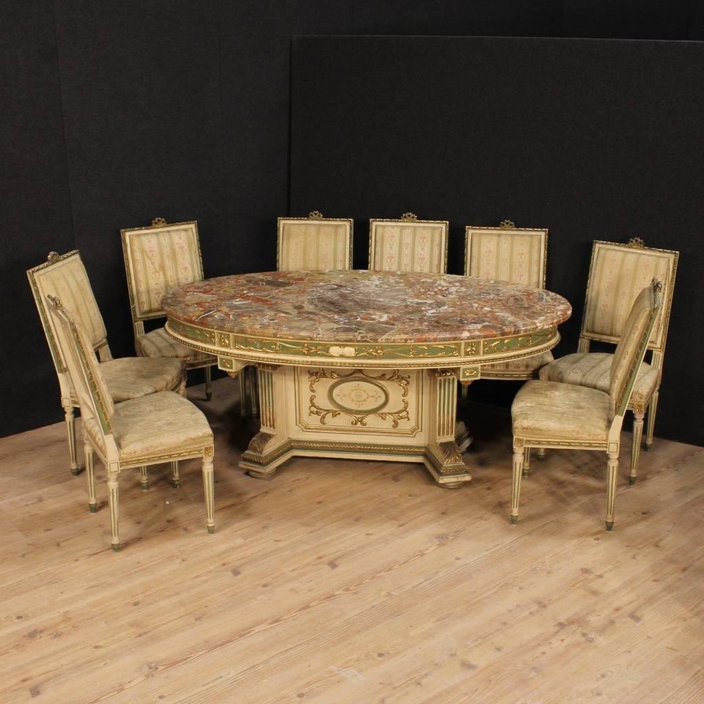 Great Italian table of mid-20th century. Furniture in ornately carved, lacquered, golden and hand-painted wood of fabulous decoration and good taste. Oval table equipped with original marble top in perfect condition, of great size and service.
