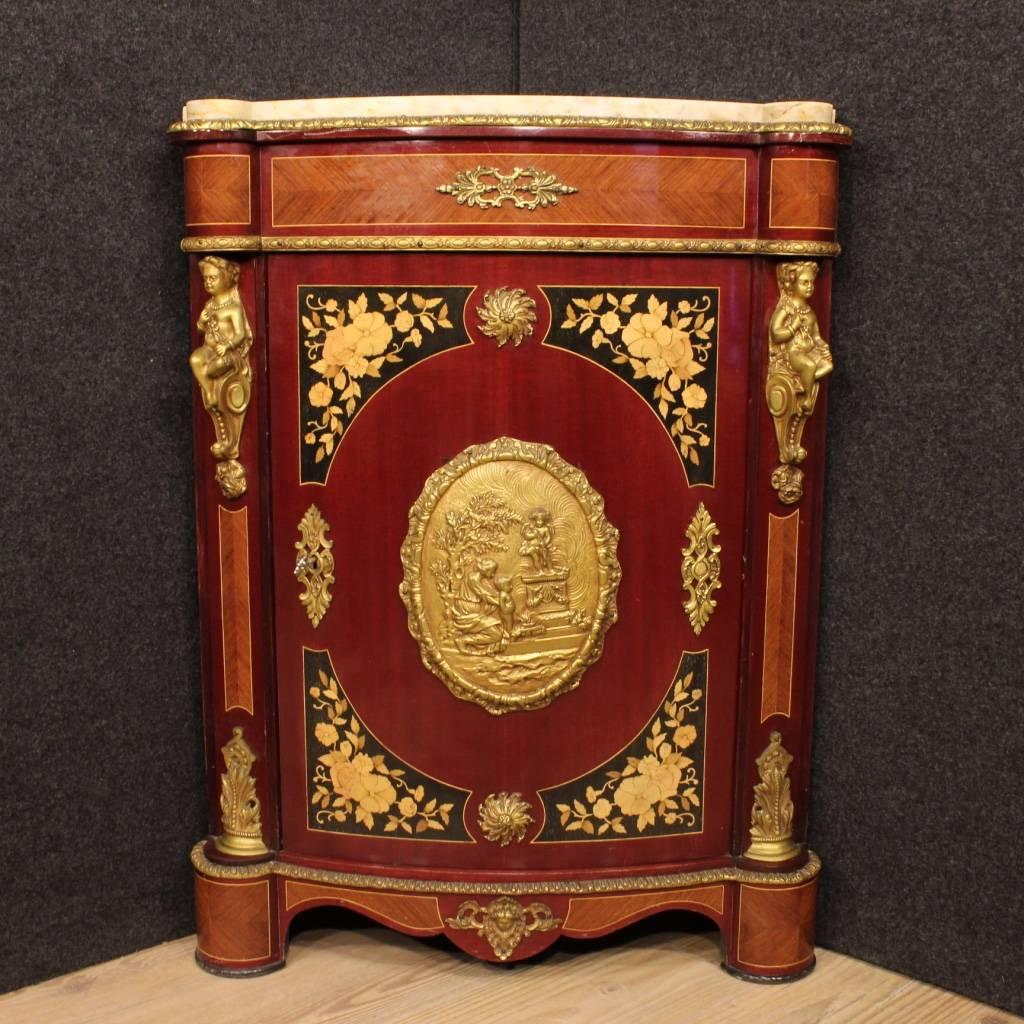 Beautiful French corner cupboard of the second half of the 20th century. Furniture nicely inlaid in rosewood, mahogany, maple, boxwood and ebonized wood, of high quality and good taste. Corner cupboard richly decorated with gilt and chiselled