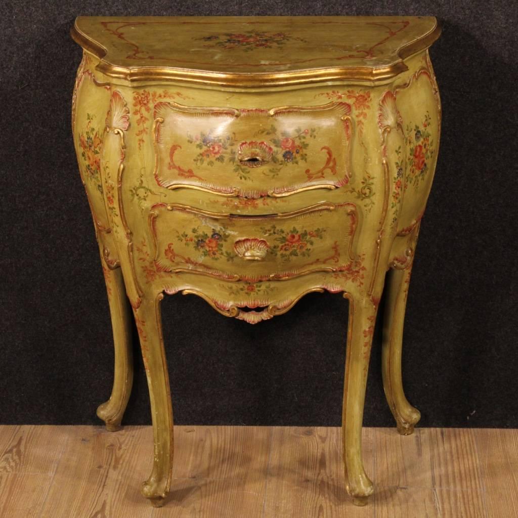 Venetian nightstand in carved, gilded, lacquered and hand painted wood with floral motifs. Furniture with two drawers of good ability and service. Bedside table from the mid-twentieth century, of beautiful proportion, ideal for a bedroom but it can