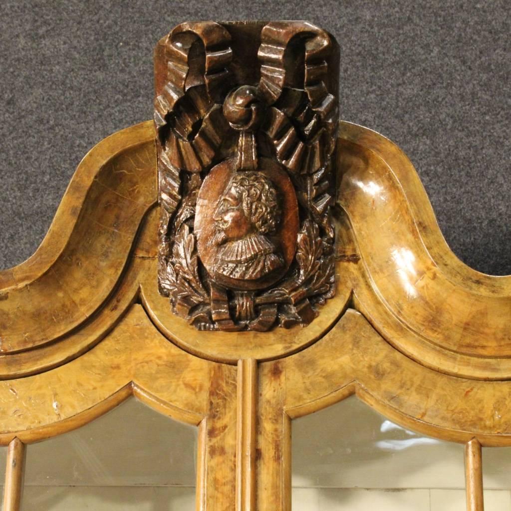 Dutch showcase of the first half of the 20th century. Furniture of high quality and special design carved in walnut and burl walnut. Bookcase with two doors and three drawers, of large capacity and service, ideal to be inserted into a living room or