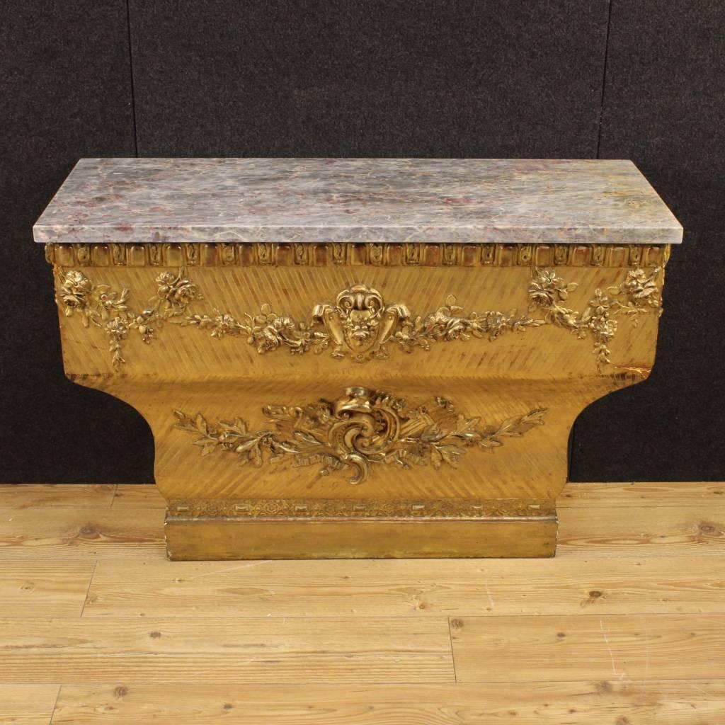 Spanish console table of the second half of the 19th century. Furniture in wood and plaster richly carved and gilded of great quality. Top in marble not original in perfect condition, of the 20th century. Console table of particular proportion and