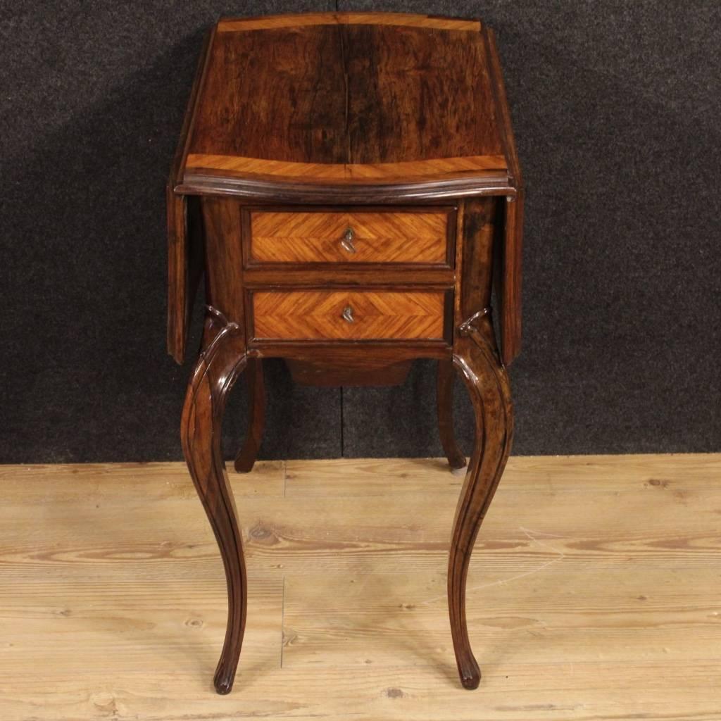 Side table of the late 19th century. High quality furniture carved in rosewood and palissander. French table with two drawers and a removable compartment underneath of discrete capabilities. It presents on the opposite side a fall-front door with an