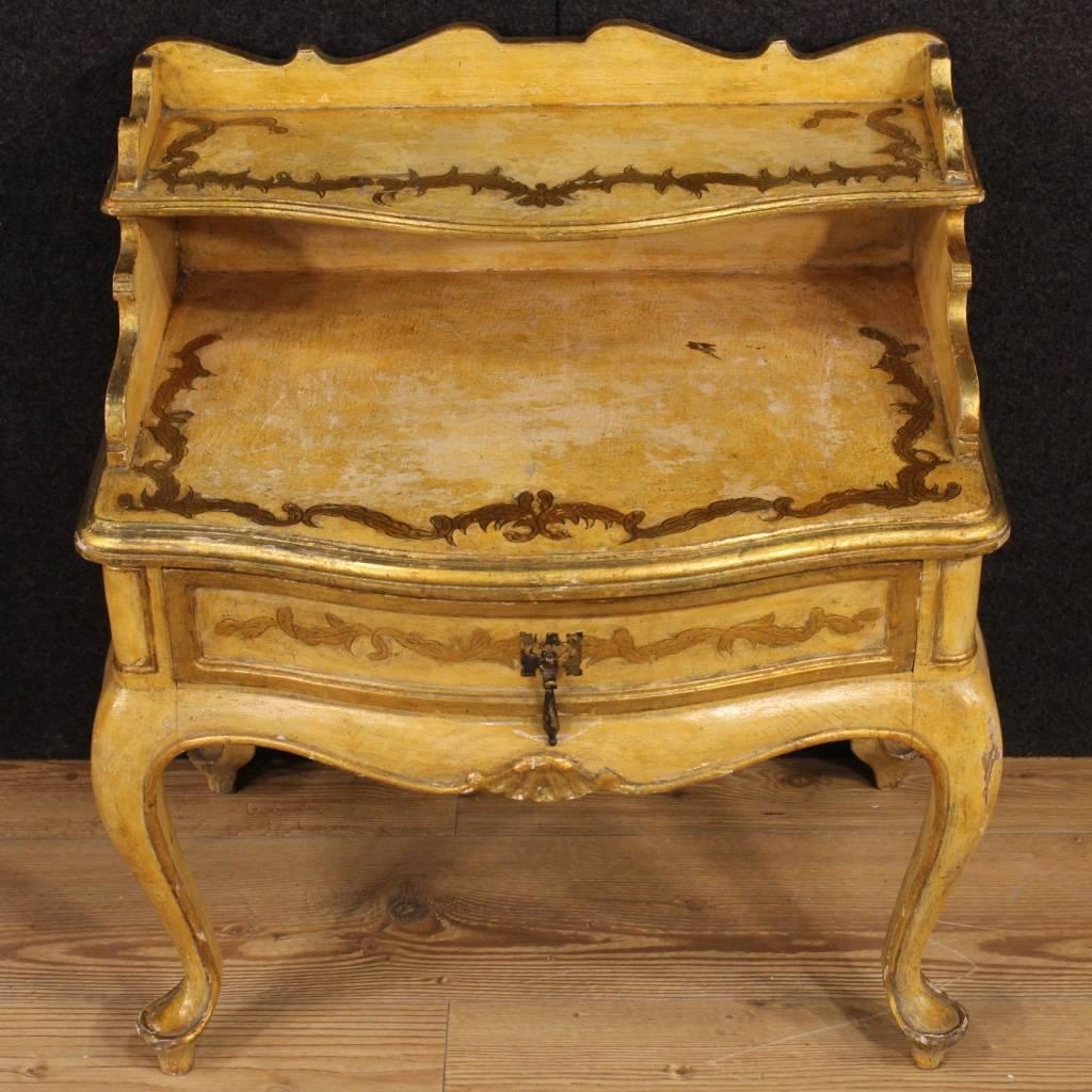 Spanish nightstand of the 20th century. Furniture in nicely carved, lacquered and gilded wood of beautiful decoration. Side table fitted with a frontal drawer and two small shelves of discreet service. It has some color drops, overall in good state