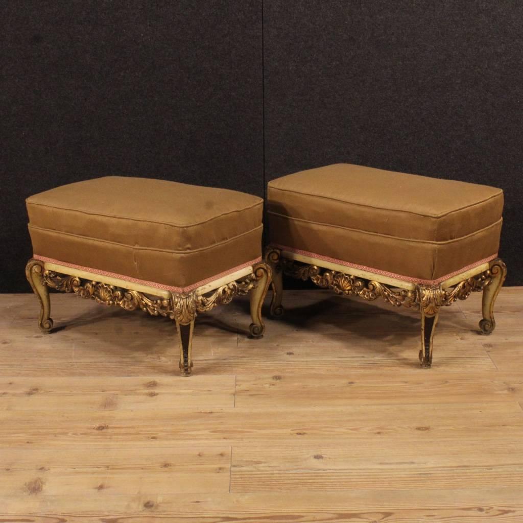 Pair of Spanish footstools from 20th century. Furniture in richly carved, lacquered and golden wood. Stools covered in fabric with some signs of wear. Padding in good condition. Furniture of beautiful decoration, difficult to find. They have