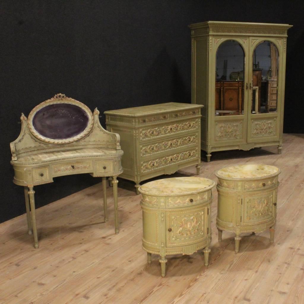 Italian wardrobe of the 20th century. Richly carved, lacquered and hand-painted wooden furniture with in decorations Louis XVI style. Wardrobe with two doors with mirrors of great capacity and service. Furniture of great decoration ideal to place in