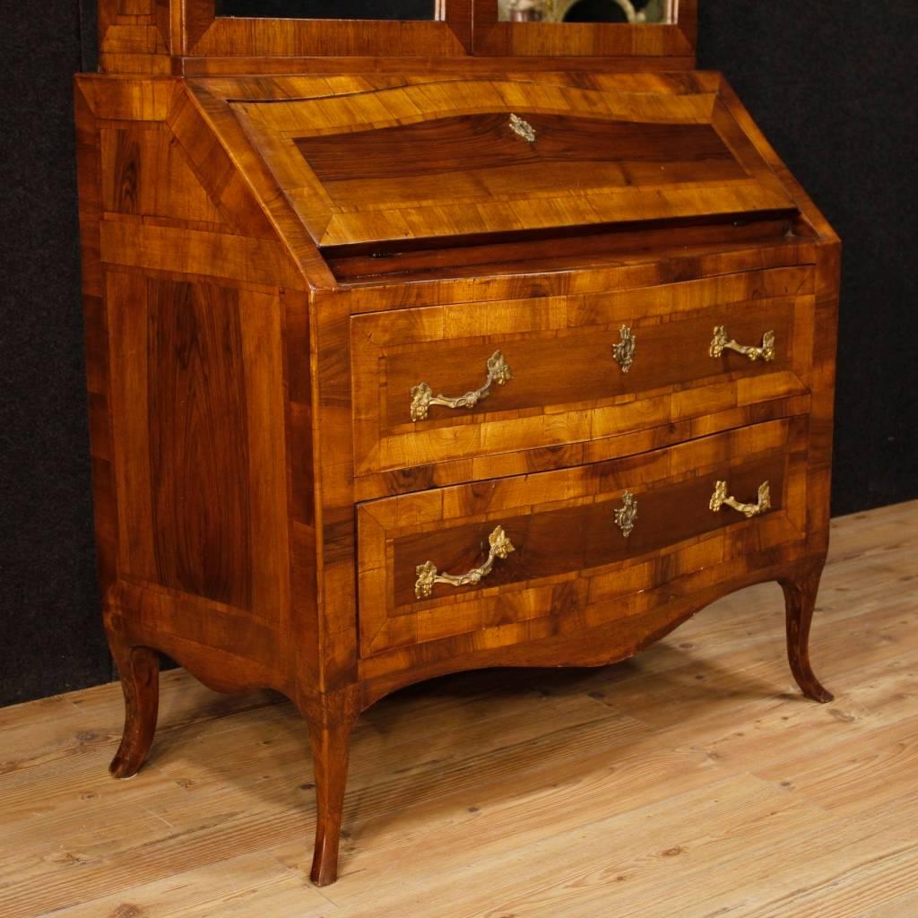 Venetian trumeau of the 20th century. Furniture in walnut of high quality decorated with golden and chiselled bronze handles. Double body furniture with two external drawers of good capacity, fall-front with two inside drawers and desk top. Upper