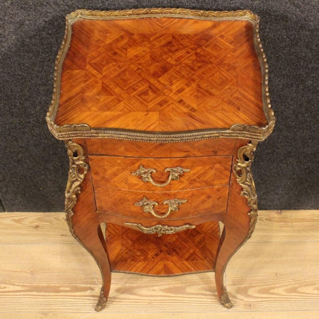 French nightstand of the 20th century. Furniture in rosewood, richly decorated with bronze. Side table finished for the centre with two shelves and three drawers of good service. In good condition.