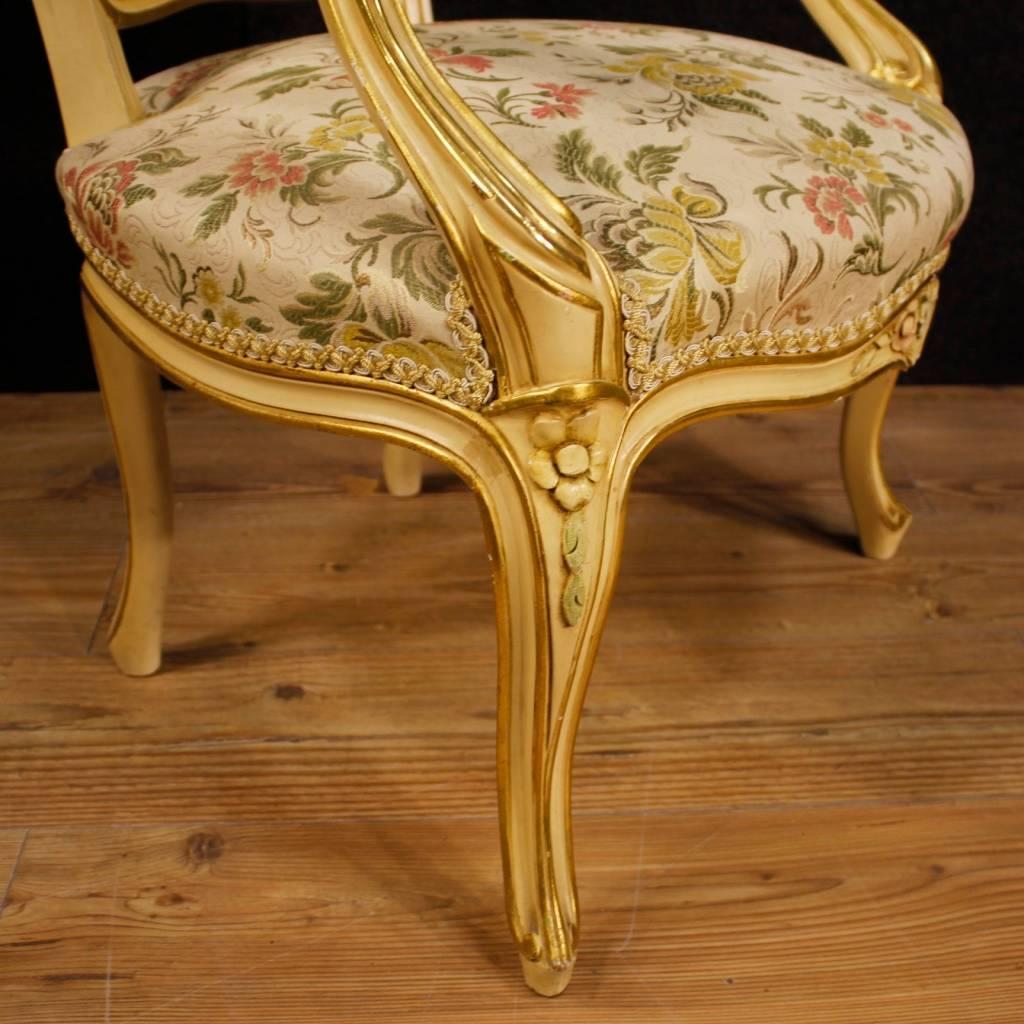 Pair of Italian armchairs of the 20th century. Furniture of good quality in carved, lacquered and golden wood. Comfortable armchairs ideal for inserting into a room or sitting room. Armchairs covered in fabric with floral decorations, backs