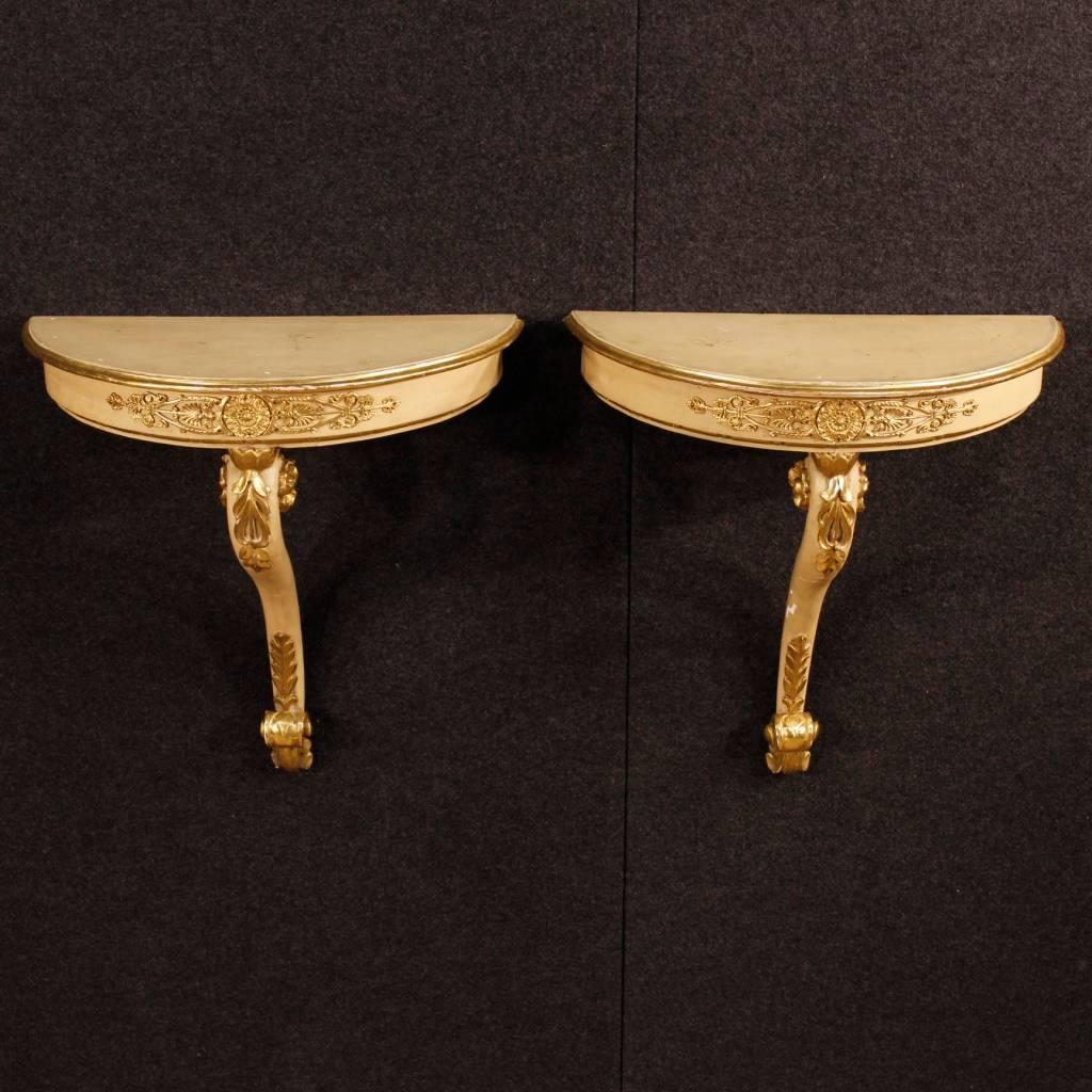 Pair of French console tables from the mid-20th century. Furniture in pleasantly carved, lacquered and golden wood of excellent quality. Console table to be fixed to wall, with wooden top in character. Furniture of discrete utility frontally