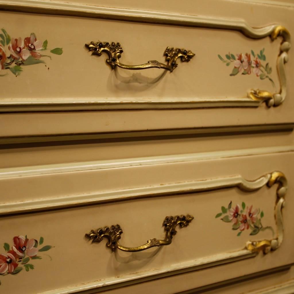 Italian dresser of the 20th century. Furniture in richly lacquered, golden and hand-painted wood of fabulous floral decorations. Chest of drawers in Venetian style with four exterior drawers of great capacity and service. Top in character, also