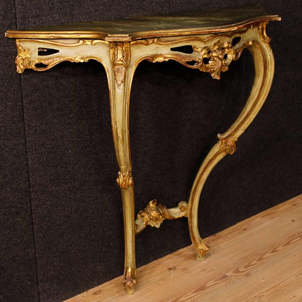 Venetian console table with mirror from 20th century. Furniture in carved, lacquered and golden wood of good quality. Console table with two legs, to fix to the wall for perfect stability. Top of discrete measure and service, lacquered faux marble.