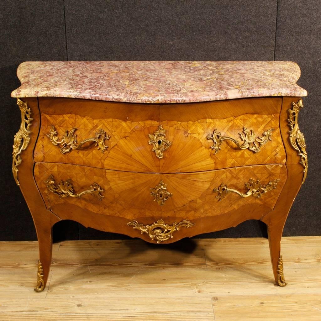 French dresser in Louis XV style from the mid-20th century. Furniture elegantly inlaid in mahogany and rosewood. Dresser with two drawers richly decorated with golden and chiseled bronze handles and ornaments. Chest of drawers of excellent quality