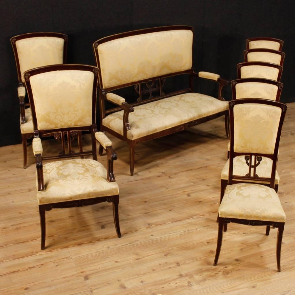 Pair of Spanish Modernist armchairs. Furniture in carved mahogany with gilded profiles. Elegant armchairs decorated with sculpted floral elements, typical of French Art Nouveau and Italian Liberty. Furniture ideal to be placed in a living room or