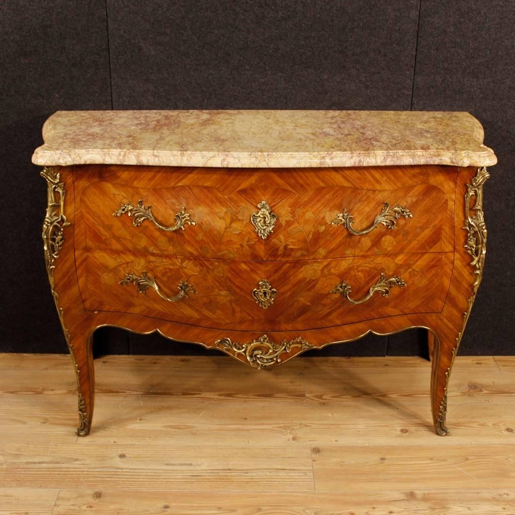 Elegant French Louis XV style dresser from the mid-20th century. Furniture of fabulous line with floral inlay in rosewood, maple and fruitwood. Chest of drawers decorated with bronze and golden brass garniture, top in original marble. Dresser with