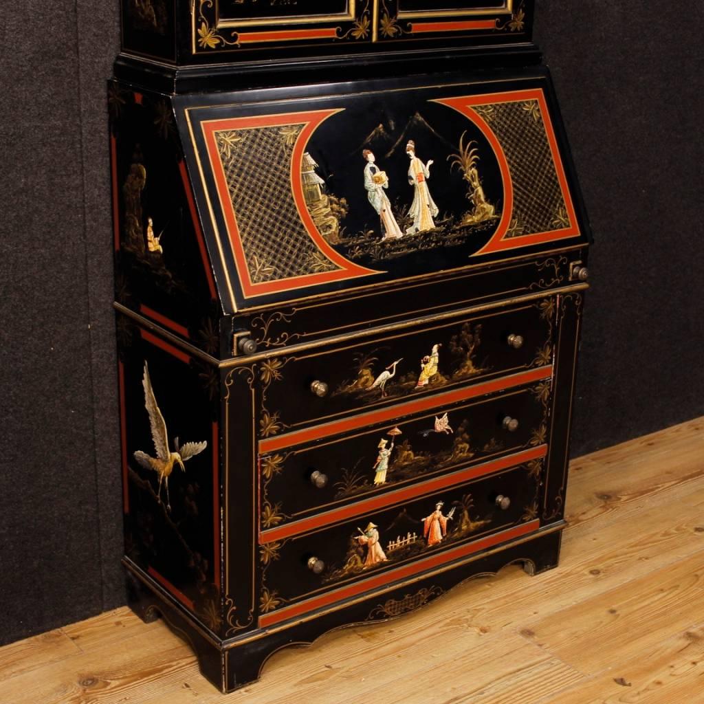 Venetian Trumeau of the 20th century. Double body furniture in richly lacquered and painted wood with chinoiserie decorations. Lower body with three drawers of good capacity. Fall-front with four drawers, various door openings and good sized desk