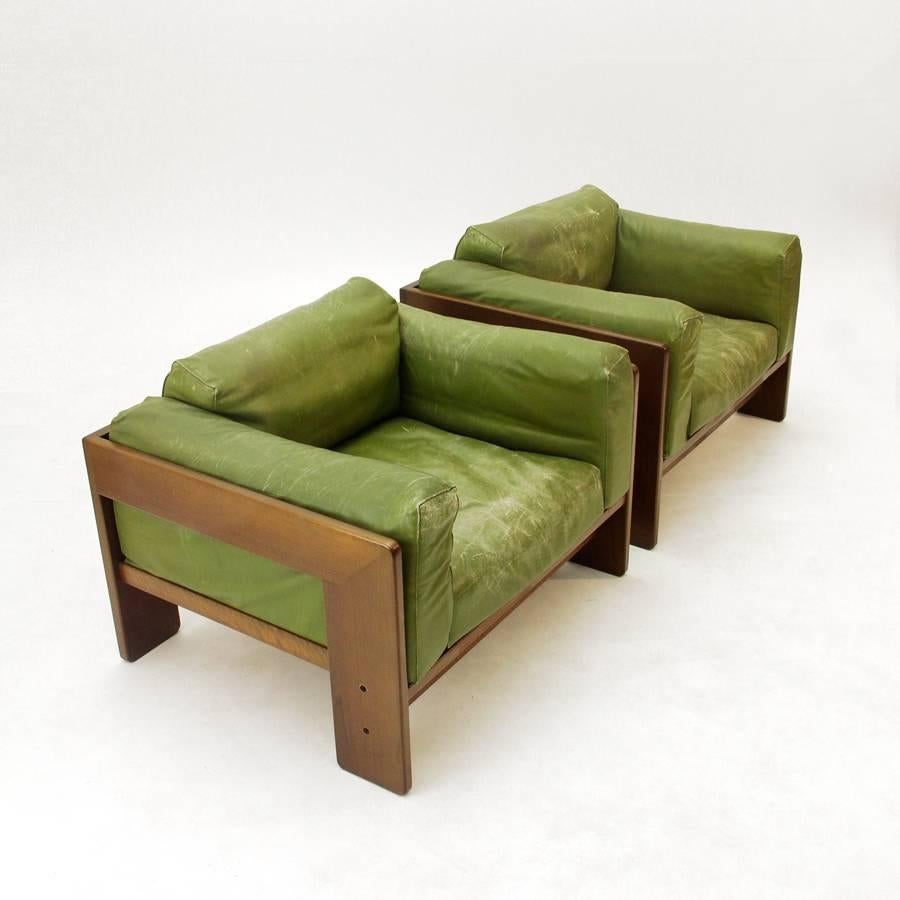 This set of two armchairs was designed by Tobia Scarpa for Gavina in 1962 in Italy. The wooden frame and cushions are in excellent condition, with the leather showing signs of use.