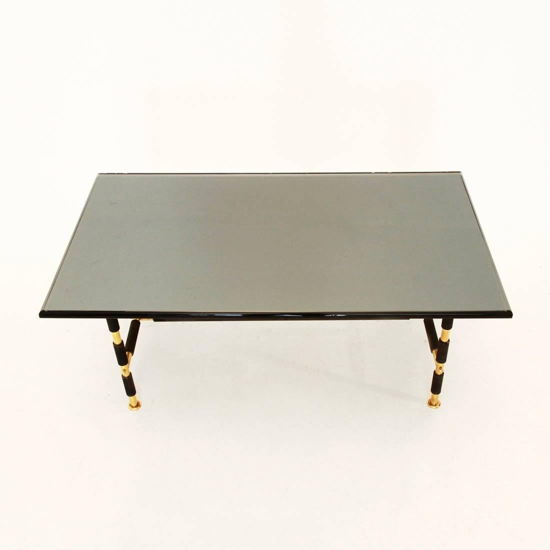 This coffee table, model 1736, was produced by Fontana Arte in 1955. It features a lacquered metal and brass frame and a beveled and mirrored glass top. In a good vintage condition.