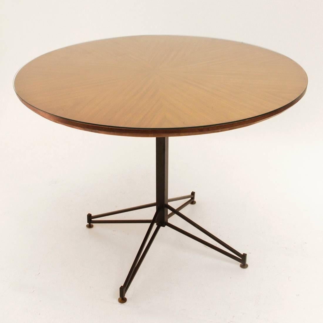Italian table designed by Carlo Ratti and produced in the 1950s.
Structure in black lacquered metal, adjustable brass feet.
Circular top in veneered wood, glass tabletop.