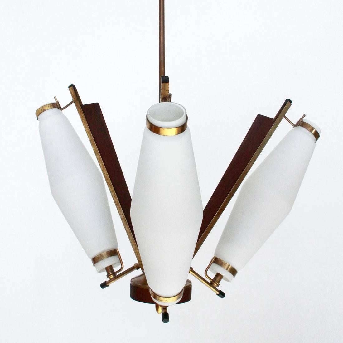 Italian ceiling lamp produced in the 1950s.
Black painted metal structure with brass and wood inserts.
Three white opal glass diffusers.
Good general conditions, some signs due to normal use over time.

Dimensions: Diameter 60 cm, height 126