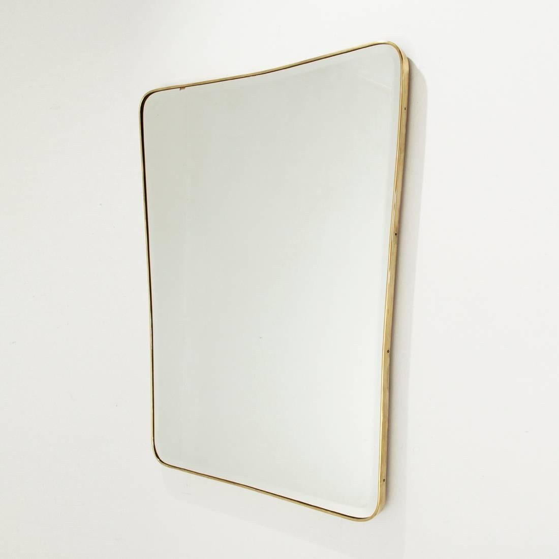 Italian mirror production of 1950s.
Wooden frame, mirrored glass with bevelled edges and brass frame.
Good general conditions, some film shadows on the mirror, frame cut into the lower edge, visible in the picture.

Dimensions: Width 79 cm,