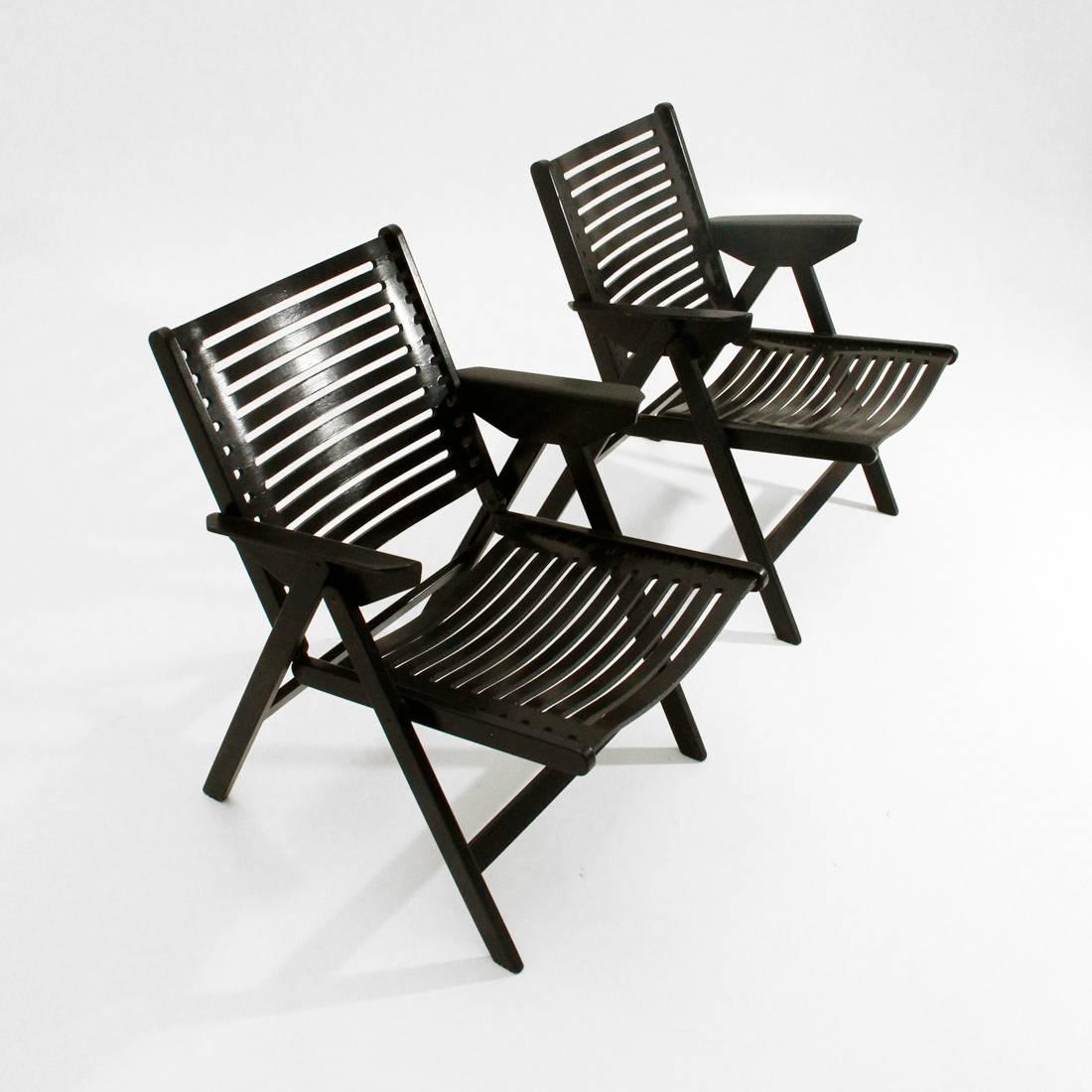 Pair of folding chairs produced in Slovenia in the 1950s by Stol, designed by Niko Kralj.
frame in hot-bent Plywood and solid wood, black varnished.
Good general conditions, some paint shortages.

Dimensions: Width 57 cm, depth 64 cm, height 73