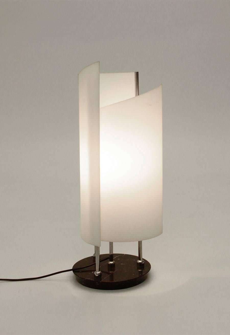 This Arianna lamp is cataloged in the Oluce archive and was designed in a style typical of the 1970s. The lamp will be polished before shipping. Dimensions: Closed 27 cm, open 55 cm.
The designer Bruno Gecchelin was born in Milan in 1939. He