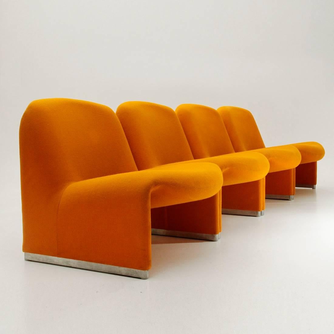 Four armchairs produced by Anonima Castelli by Giancarlo Piretti.
Wooden structure, padded and lined with orange fabric.
Metal feet.
Structure in good condition, fabric with some stains.

Dimensions: Width 65 cm, depth 75 cm, height 70 cm, seat