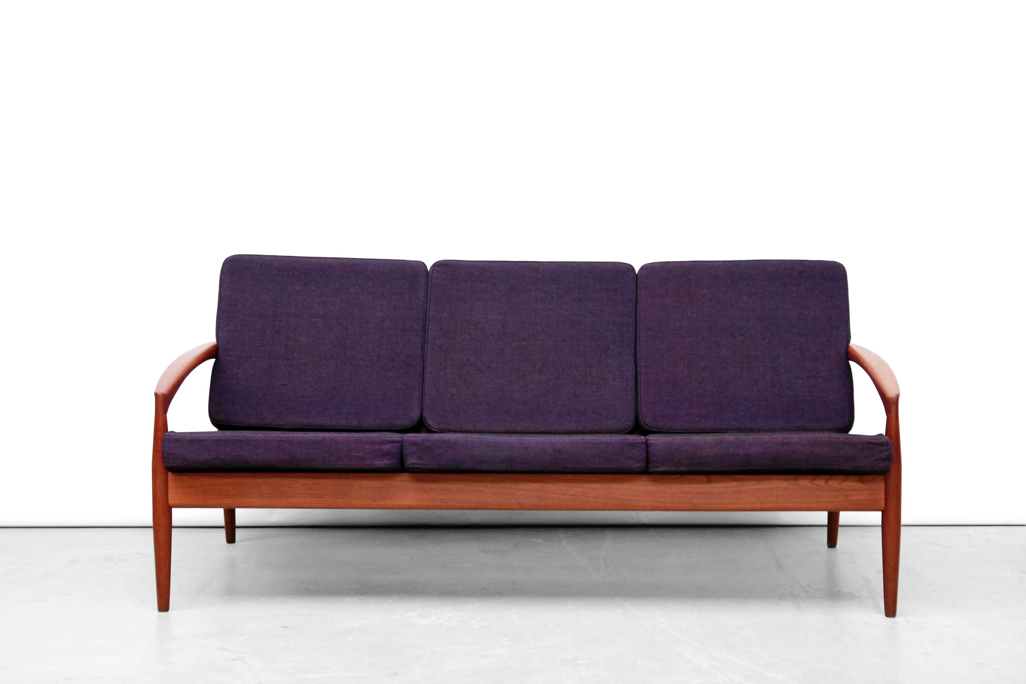 Beautiful sofa by Kai Kristiansen for Magnus Olesen, Denmark. This three-seat, model 121 (also called: paper knife), is made of solid teakwood and is of superb quality. Great clean lines and amazing details. The sofa cushions have new foam, but the