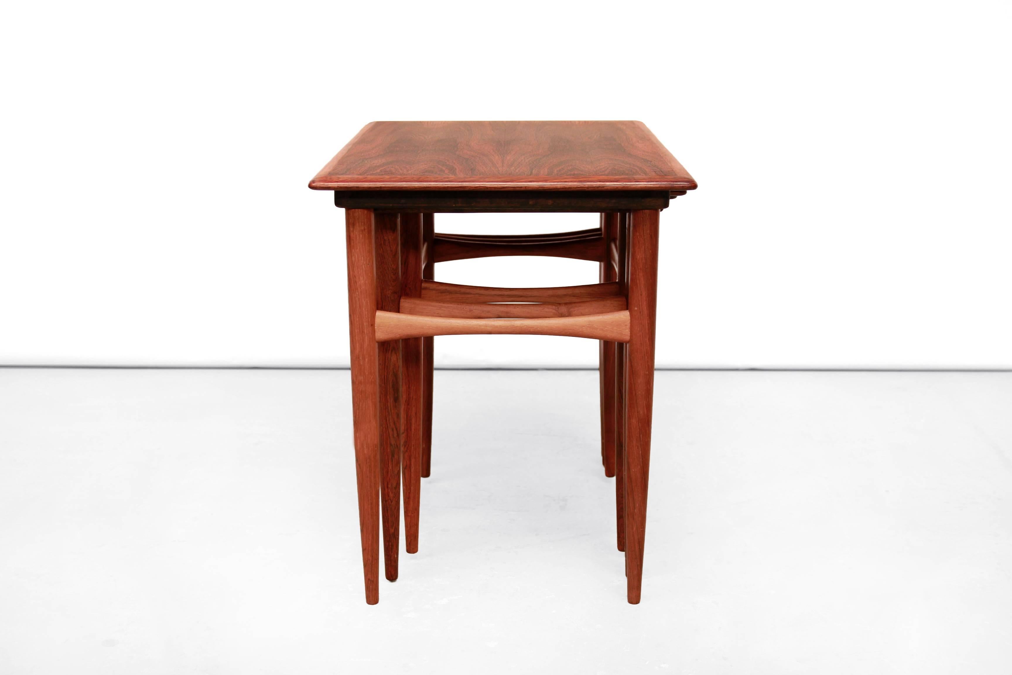 Very beautiful set of three rosewood nesting tables designed by Poul Hundevad for Fabian, Denmark in the 1960s. These nesting tables are made of partly solid rosewood and partly veneer. This set of tables will fit in every interior style. The tables